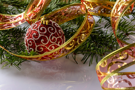 Christmas festive card with fir branches, Christmas ball and festive decor on the white background .  Space for an object.の写真素材