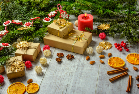 Christmas festive card with fir branches and festive decor on the white wood background.  Space for an object.の写真素材