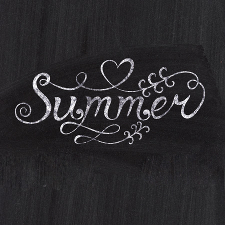 Spring concept. Chalk drawing card with "Spring" lettering on chalkboard blackboard. Greeting card with hand-drawn lettersの写真素材