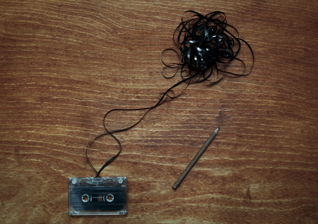 Retro cassette tape with ribbon and pencil. Copyspace included. Vintage effected photoの写真素材