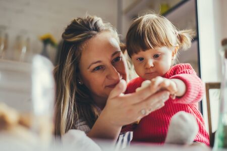 Happy family in the kitchen. Mother and daughter are preparing the christmas cookies.の写真素材