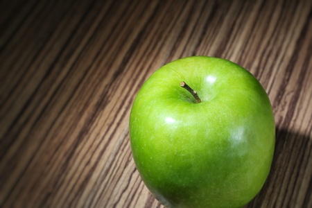 green apple on wooden tableの写真素材