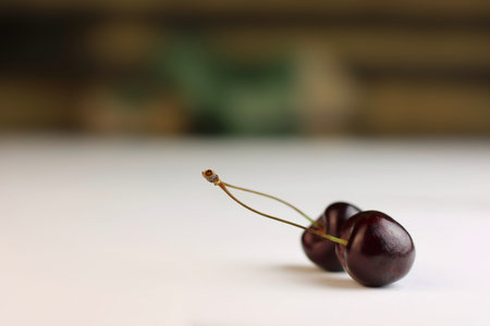 Two heart shaped cherry berries isolated on white background