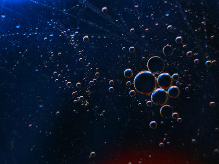 abstract colorful backdrop with oil drops on water surface. possible themes for the application -...