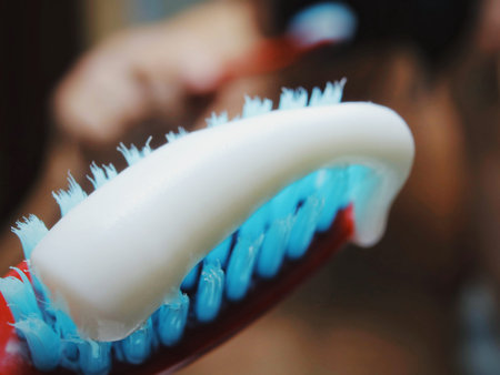 toothbrush with toothpaste. Toothpaste on a white toothbrush. Toothbrush - macro. Toothpaste -...