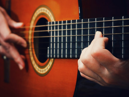 Guitar in the hands. Plays guitar. Guitar Strings. Guitar in vintage style.