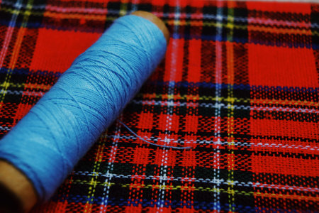 checkered fabric and sewing tools background. Handmade concept.