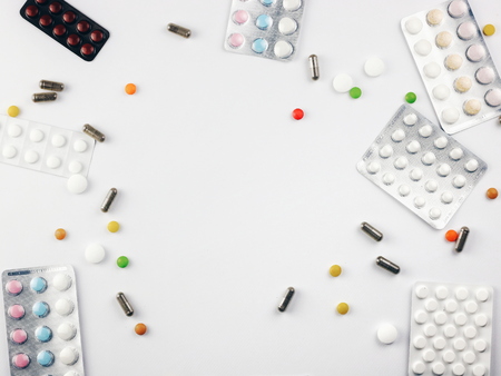 Medical pills on white background. Flat lay frame composition.の写真素材