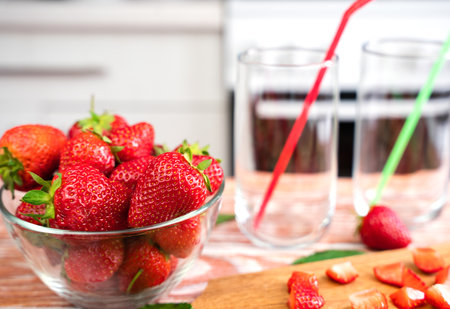 Ripe juicy strawberries for making lemonade on the table in the kitchen. Delicious homemade lemonade with fresh strawberries. selective focus.の写真素材