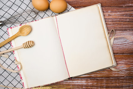 Blank vintage recipe book and on the wooden kitchen table. Close-up. Place for text. Top view.の写真素材