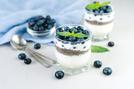 Delicious and healthy dessert with yogurt, chia seeds and fresh blueberries on the table. Healthy breakfast. ?lose-up.の写真素材