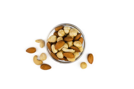Mix of nuts in a glass bowl isolated on white background. Top view. Healthy food. Banner. Close-up.の写真素材