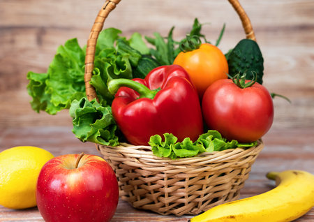 Healthy vegetables and fruits in the basket and on the table. Close-up.の写真素材