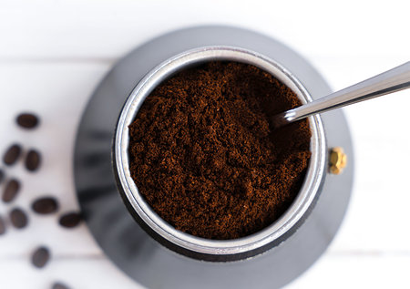 Fresh fragrant ground coffee in a geyser coffee maker. Brewing natural coffee in a geyser coffee maker. Top view. Selective focus.