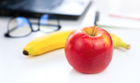 The concept of a healthy food at work. Fruits on the desktop. Close-up. Selective focus.の写真素材