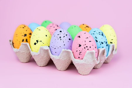 Colorful decorative Easter eggs on the pink background. Close-up. Selective focus.
