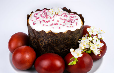 Easter cake and colored eggs on the plate. Close-up. Selective focus.