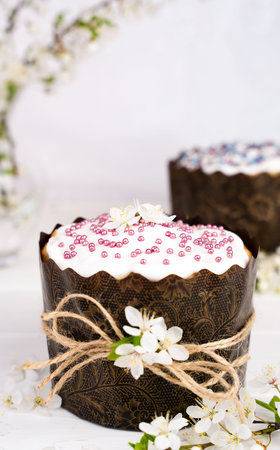 Easter cake decorated with white icing and a sprig of cherry blossoms. Christian traditions....