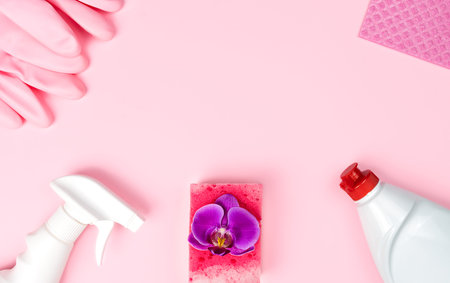 Spring cleaning. Detergent, cleaning products, kitchen sponges and rubber gloves lie in the shape of...