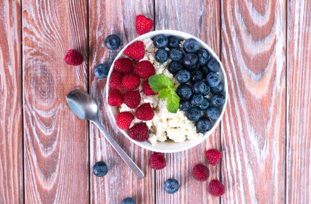 A homemade cottage cheese and fresh ripe berries for breakfast. Delicious and healthy dessert. ?lose-up. Top view.の写真素材