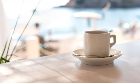 Cup of espresso in a summer cafe on the beach. Relaxation by the sea. Close-up. Place for text. Selective focus.の写真素材