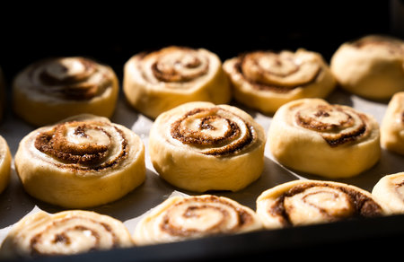 Appetizing cinnamon rolls. The process of making buns. Raw dough for buns. Close-up. Selective focus.の写真素材