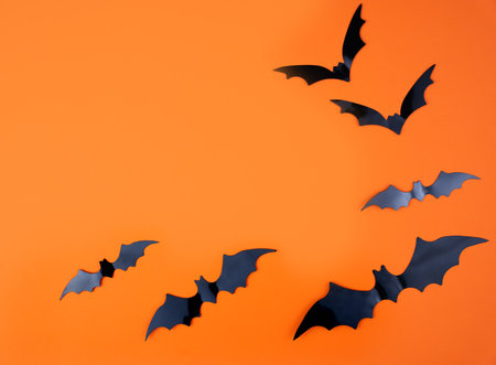 Background for Halloween with bats on an orange background. Mockup. Flatlay. Copy space.の写真素材