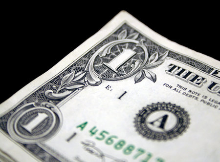 A US one dollar bill showing the corner