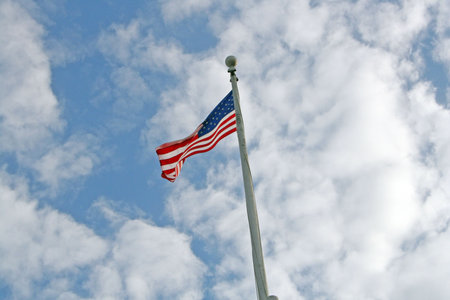 The USA flag on a flag pole waving in the wind
