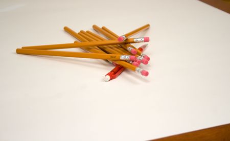 Outnumbered Mechanical Pencil v1 or Dogpile or One versus Many or Old versus new is a gang of standard number two pencils piling onto a red mechanical pencilの写真素材