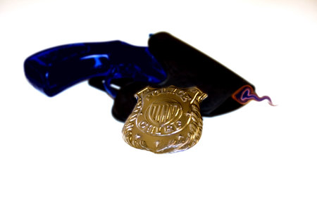 Smoking Gun Abstract simulates a smoking gun image with a law enforcement badge isolated on a white background.の写真素材