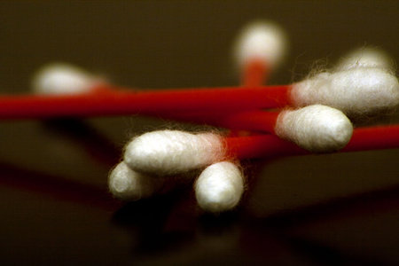 Cotton Swabs with red shafts are captured using depth of field to show the detail in the white...