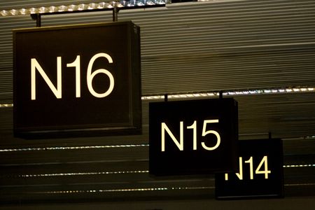 Airport Terminal Gates N are direction signs to airline travelers for departing or arriving flights. Also baggage claim uses gate numbers to pick up your bags.の写真素材