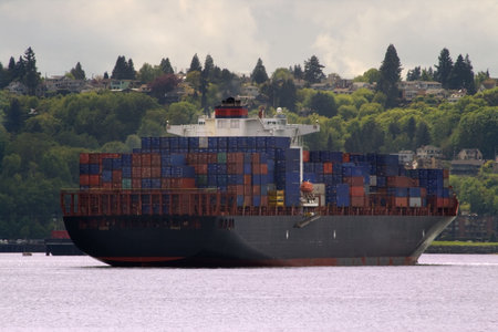 Container Ship with smoke or steam coming out of the top of the stack. Logos have been obscurred or...