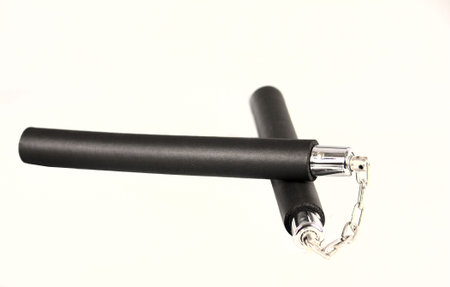 Nunchaku (Nunchaks Numchuks Nunchukas Chucks Chain Sticks) are traditional Japanese Martial arts weapon illegal in some countries and often depicted as being used by ninja in tv or the movies.の写真素材