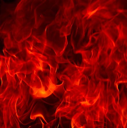 Red Fire Flames of Hell against a black background.の写真素材