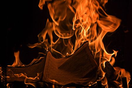 Book or Maganize Burning Red Fire Flames of Hell against a black background.の写真素材