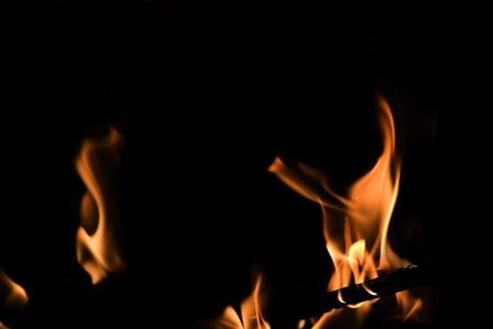 Red Fire Flames of Hell against a black background.の写真素材