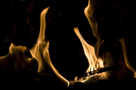 Flames of Fire in a Fireplace against a black Background 
