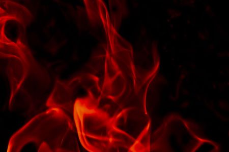 Flames Fire of Hell against a black background. の写真素材