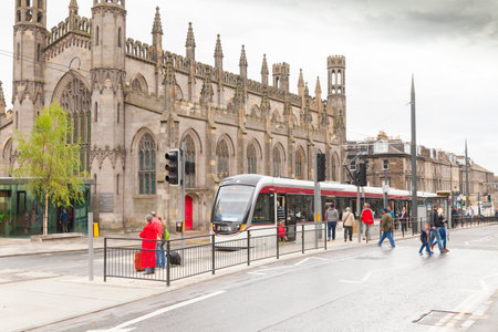 Edinburgh Scotland in summer. some tourists go up the tram linking all the major points of interest of the cityのeditorial素材