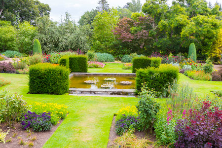 Crathes - August 2014 : Crathes gardens scotland in summer. an open-air living room immersed in the greenery where a lot of tourists take a sit after visit the homonymous castleのeditorial素材
