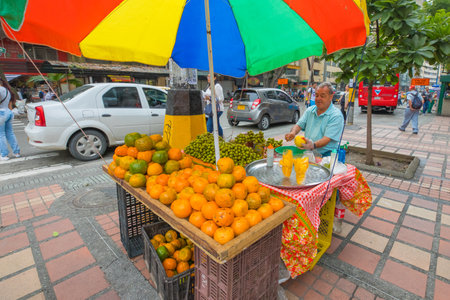 Medellin January 2018  In the morning, an old man sells fresh mandarins on his stall in a street in the center of Medellin because people love to buy fruit in the street.のeditorial素材