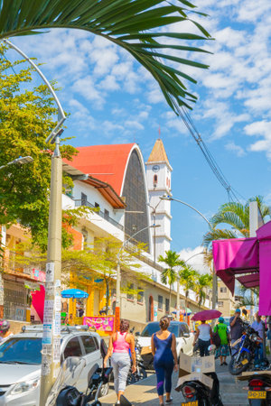 January 2018 In the morning the inhabitants walk along this street in Castilla District, Medellin,  full of shops and restaurants and conclude the walk with a visit to the church of San Judasのeditorial素材