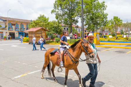Filandia March 2018 Every Sunday children ride a horse in the Bolivar square of Filandia, Colombia, known for its colonial architectureのeditorial素材