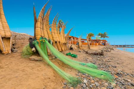 Peru July 2018 Pimentel beach and pear. One of the biggest beaches in Peru appreciated by tourists and locals. Detail of traditional boats and nets.のeditorial素材