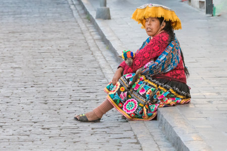 Arequipa Peru August 20, 2018 a lady in traditional clothes waits for the bus along a street in the historic center of Arequipaのeditorial素材