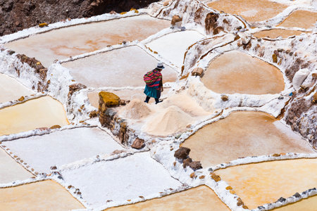 Moray Peru September 14 2018 A quechua woman is going home after a day passed working in saltpans of Moray. The extracted salt is sold to cattle farmers.のeditorial素材