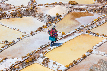 Moray Peru September 14 2018 A quechua woman is going home after a day passed working in saltpans of Moray. The extracted salt is sold to cattle farmers.のeditorial素材