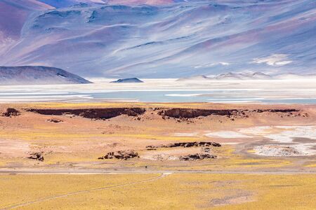Chile Atacama desert red rocks lagoon at sunsetの写真素材